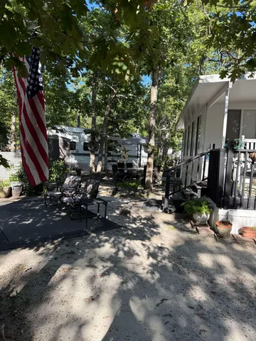 a backyard of a house with barbeque oven and outdoor seating