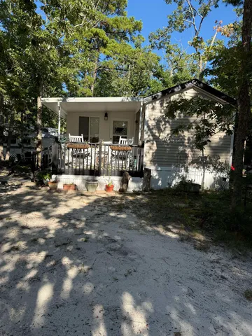 a view of house with yard and sitting area