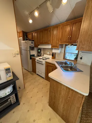 a kitchen with refrigerator and cabinets