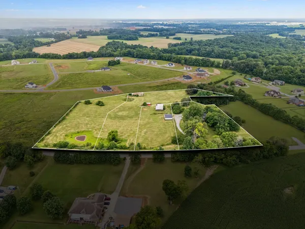 an aerial view of a house with a lake view