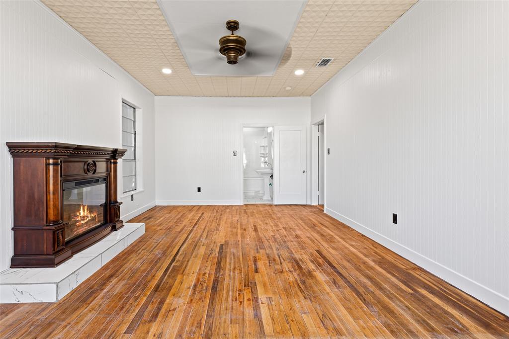 204 Jones Street Longview, TX 75602 - Photo 16 of 38 a view of empty room with wooden floor and fan