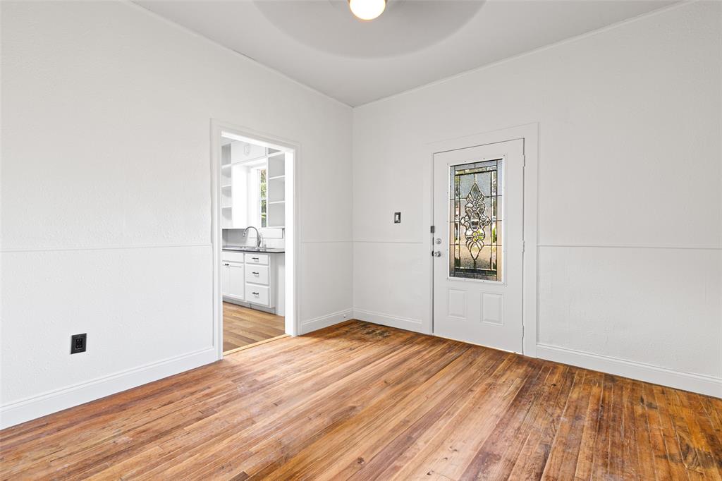 204 Jones Street Longview, TX 75602 - Photo 21 of 38 an empty room with wooden floor and windows