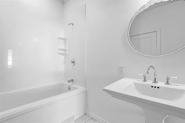 a big room with wooden floor and natural light