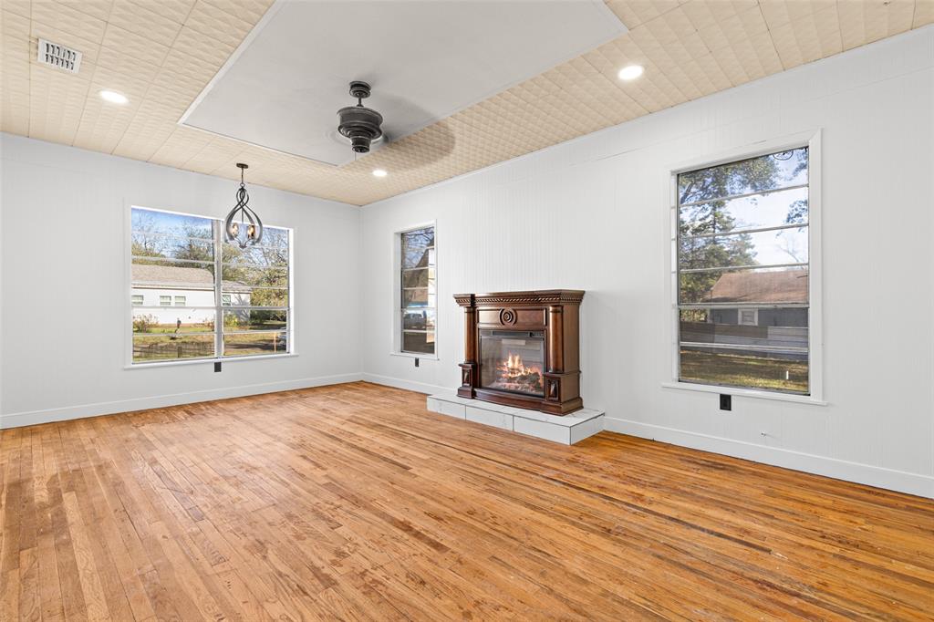 204 Jones Street Longview, TX 75602 - Photo 27 of 38 a view of an empty room with window and wooden floor