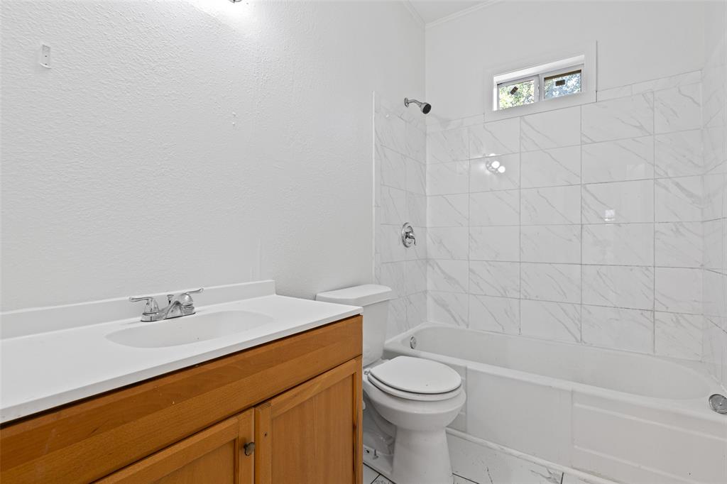 204 Jones Street Longview, TX 75602 - Photo 30 of 32 a bathroom with a sink a toilet and shower