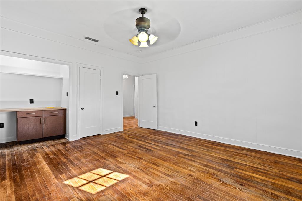 204 Jones Street Longview, TX 75602 - Photo 31 of 38 a bedroom with a bed and a chandelier