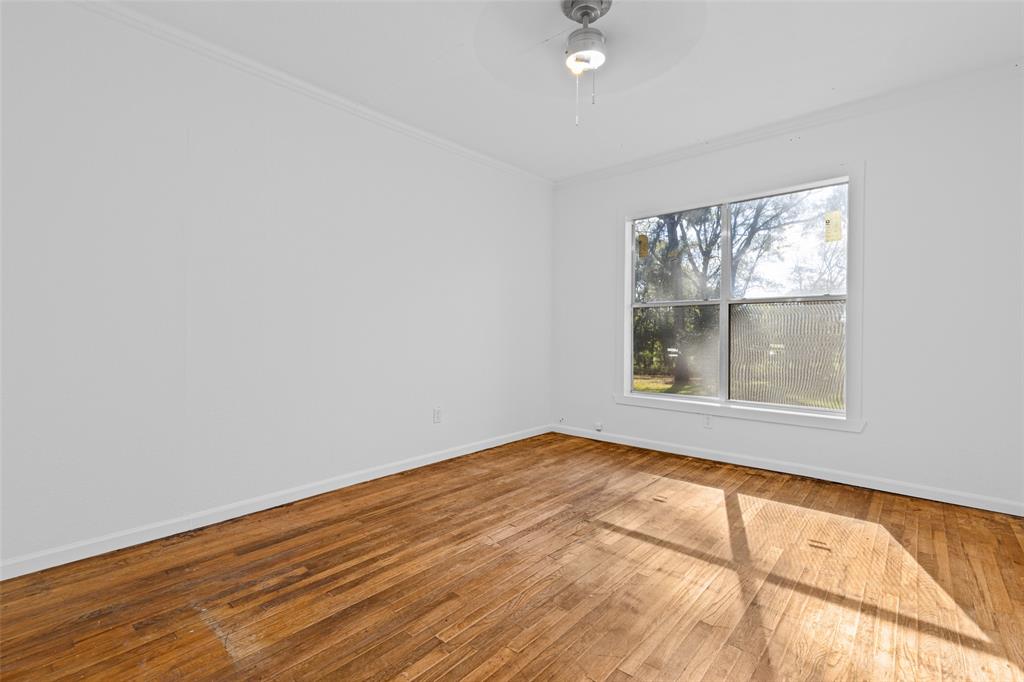 204 Jones Street Longview, TX 75602 - Photo 33 of 38 an empty room with wooden floor and windows