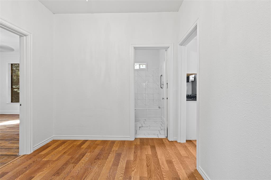 204 Jones Street Longview, TX 75602 - Photo 35 of 38 a view of an empty room with wooden floor and a window