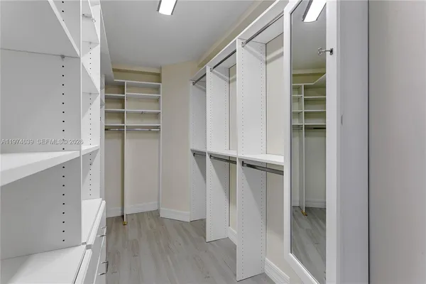 a view of walk in closet with empty racks