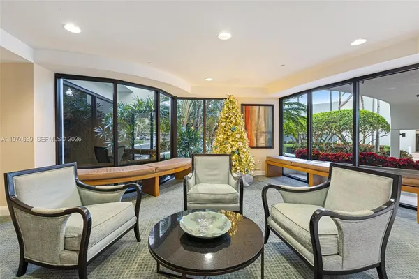 a living room with furniture and a floor to ceiling window
