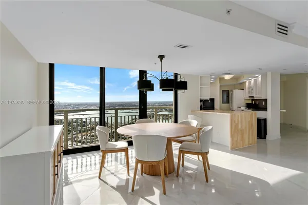 a view of a dining room with furniture and chandelier