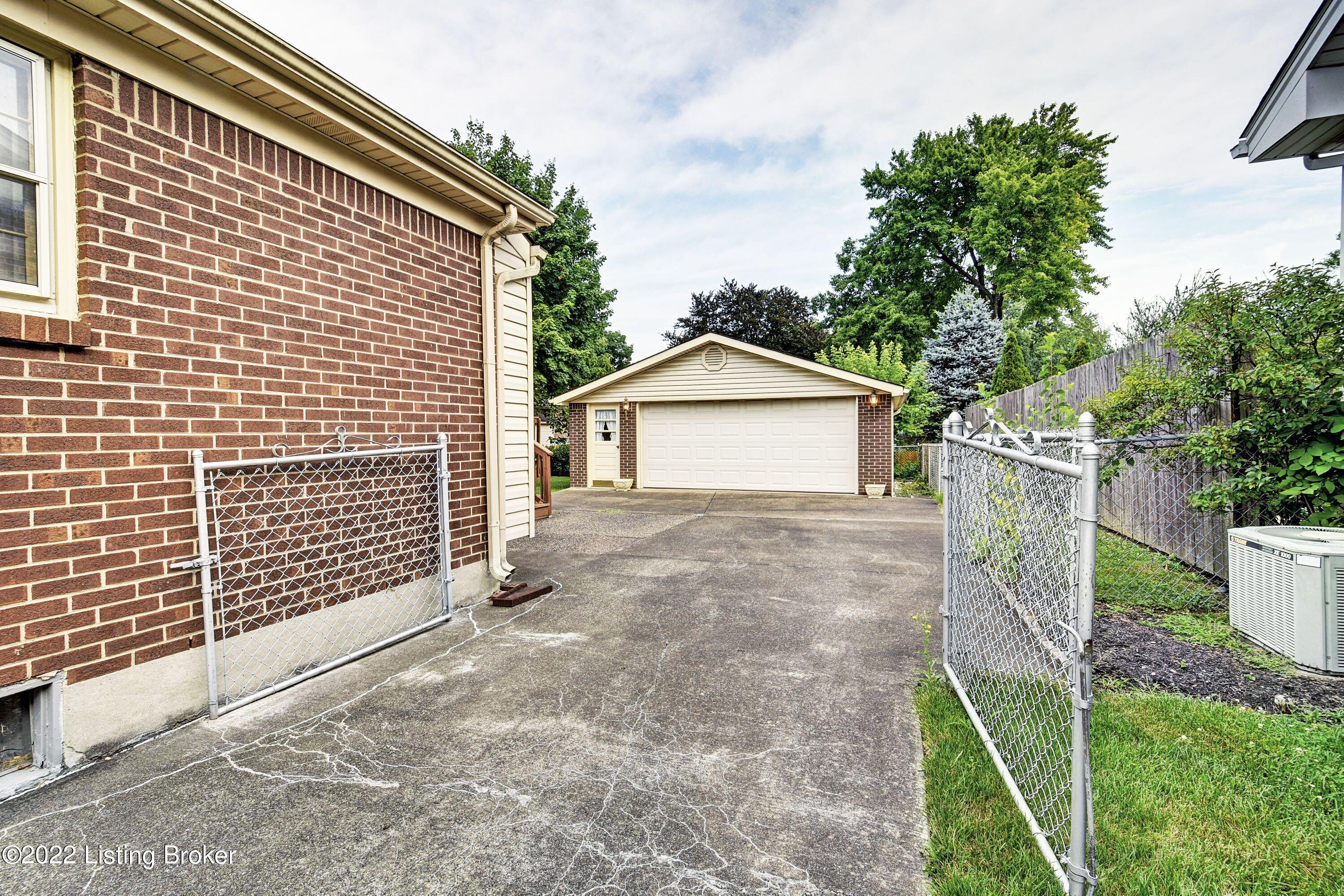 6707 Windhurst Road Louisville, KY 40207 - Photo 4 of 36 Fully Fenced Yard. Chain Link Fence With Driveway Gate.
