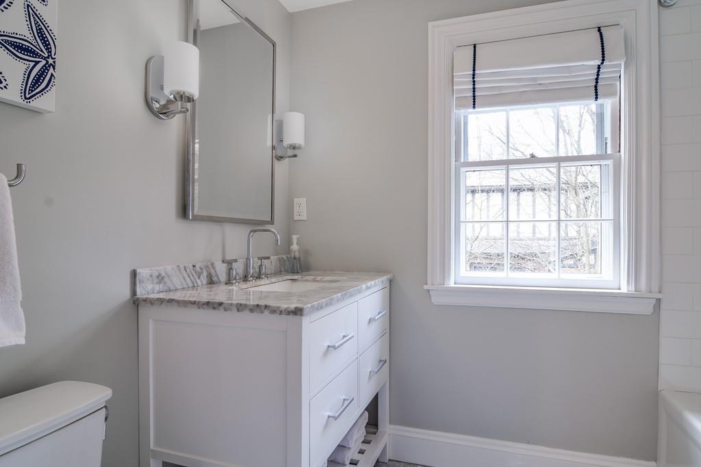 8 Fiske Road Wellesley, MA 02481 - Photo 12 of 21 a bathroom with a granite countertop sink toilet and mirror