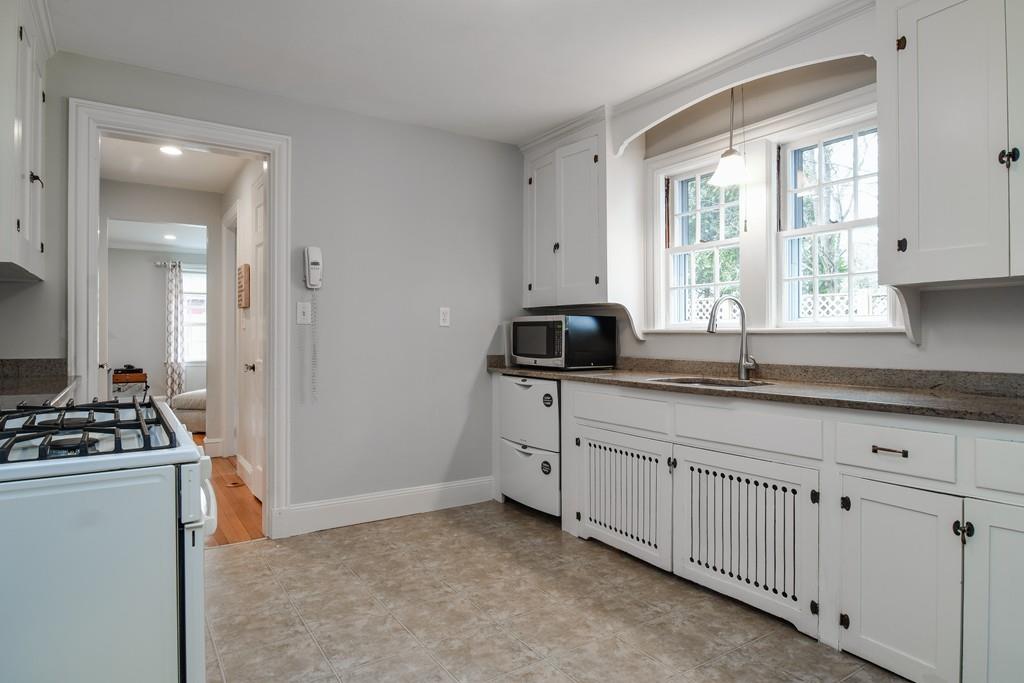 8 Fiske Road Wellesley, MA 02481 - Photo 2 of 21 a kitchen with granite countertop a sink a stove and cabinets