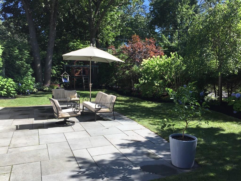 8 Fiske Road Wellesley, MA 02481 - Photo 4 of 21 a view of a patio with chair and tables back yard of the house