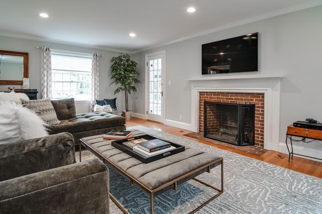 8 Fiske Road Wellesley, MA 02481 - Photo 6 of 21 a living room with furniture a flat screen tv and a fireplace