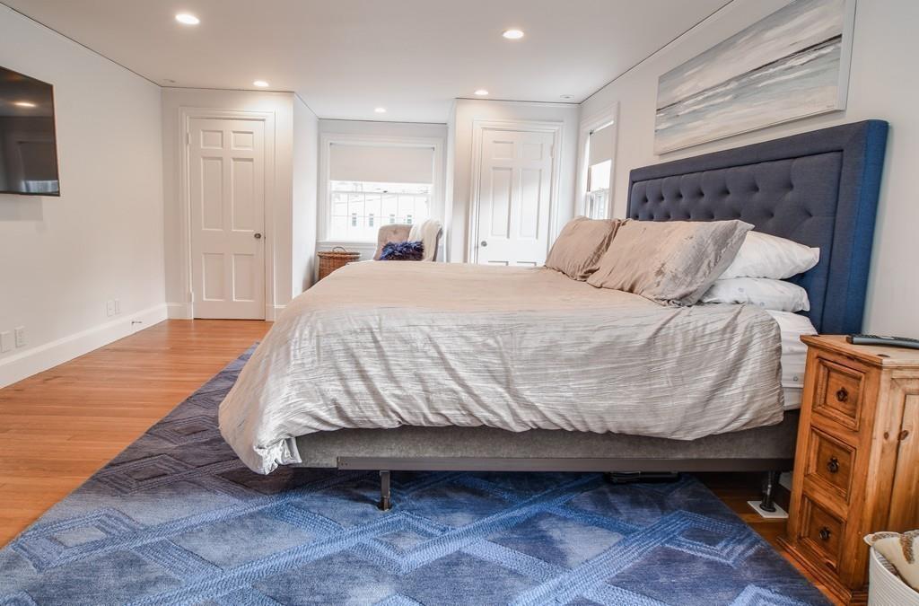 8 Fiske Road Wellesley, MA 02481 - Photo 9 of 21 a bedroom with a bed and a flat screen tv