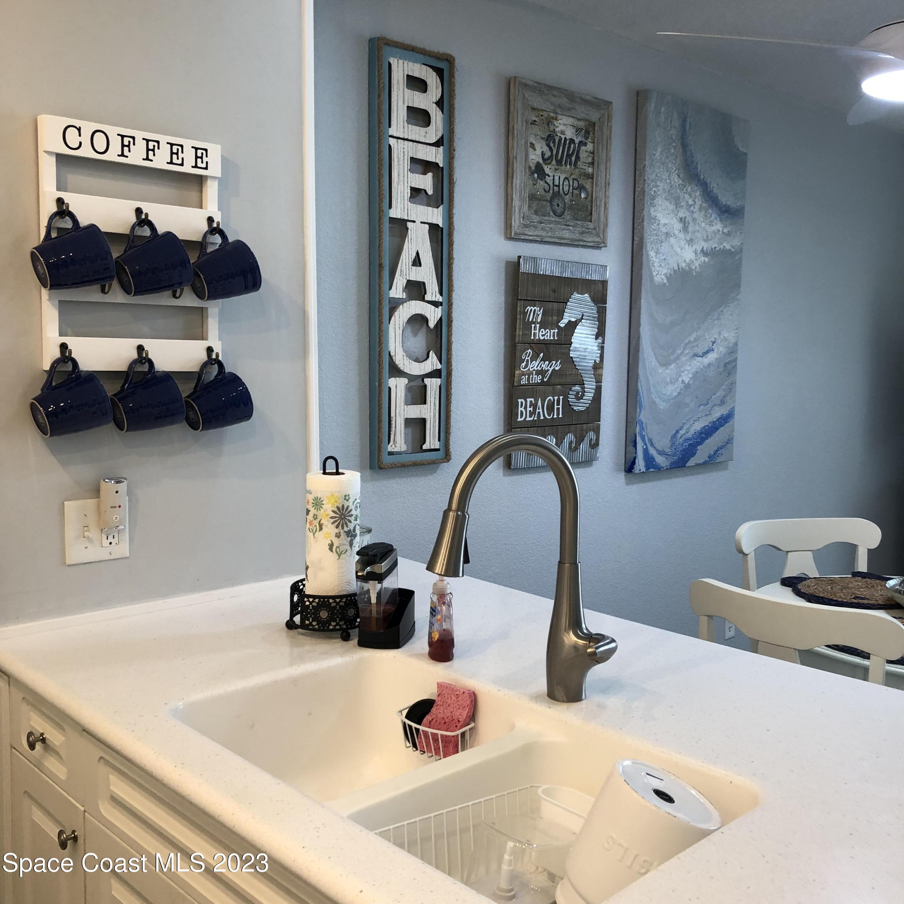 2020 North Atlantic Avenue, Unit 408S Cocoa Beach, FL 32931 - Photo 12 of 22 a bathroom with a sink and a mirror