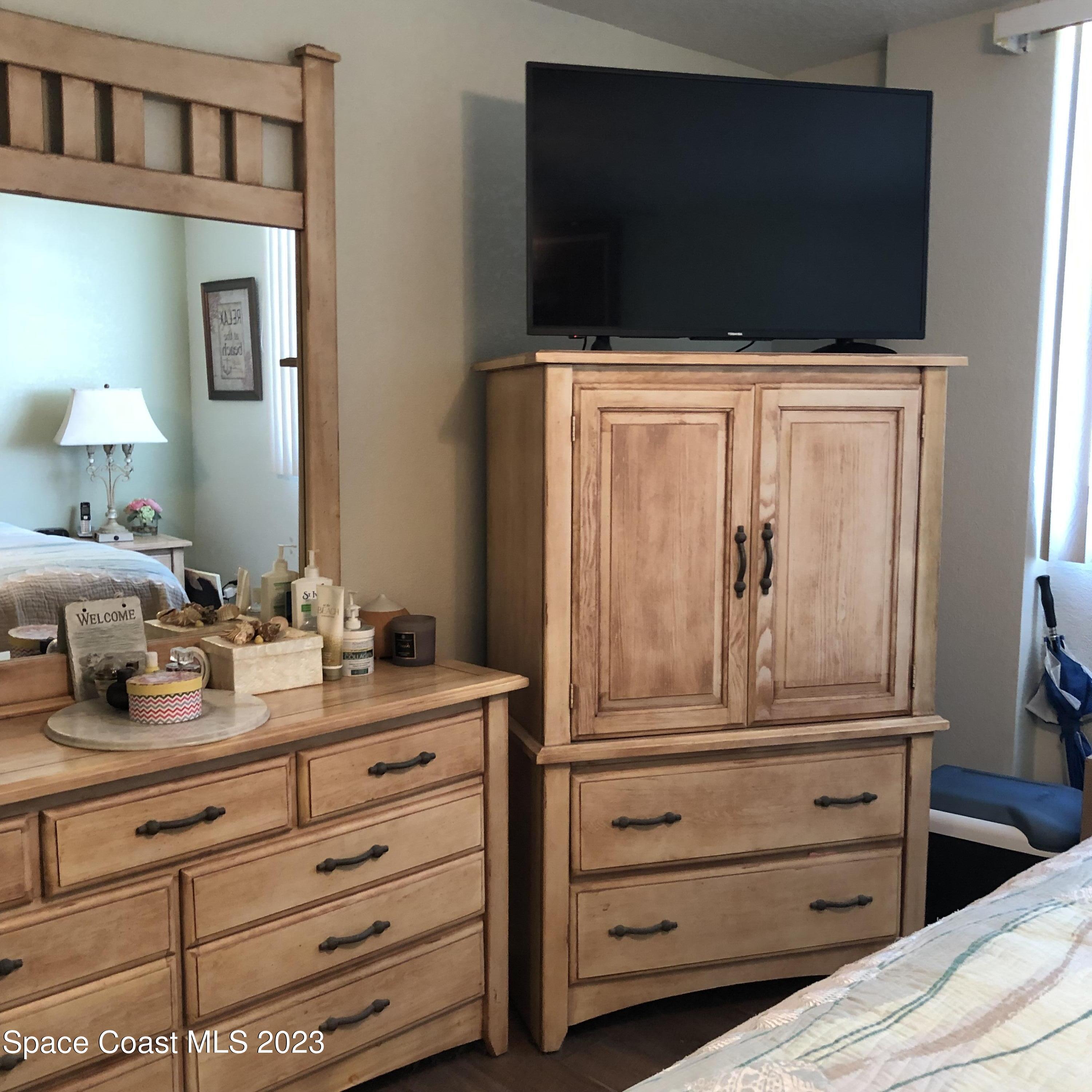 2020 North Atlantic Avenue, Unit 408S Cocoa Beach, FL 32931 - Photo 13 of 22 a view of a dresser with mirror
