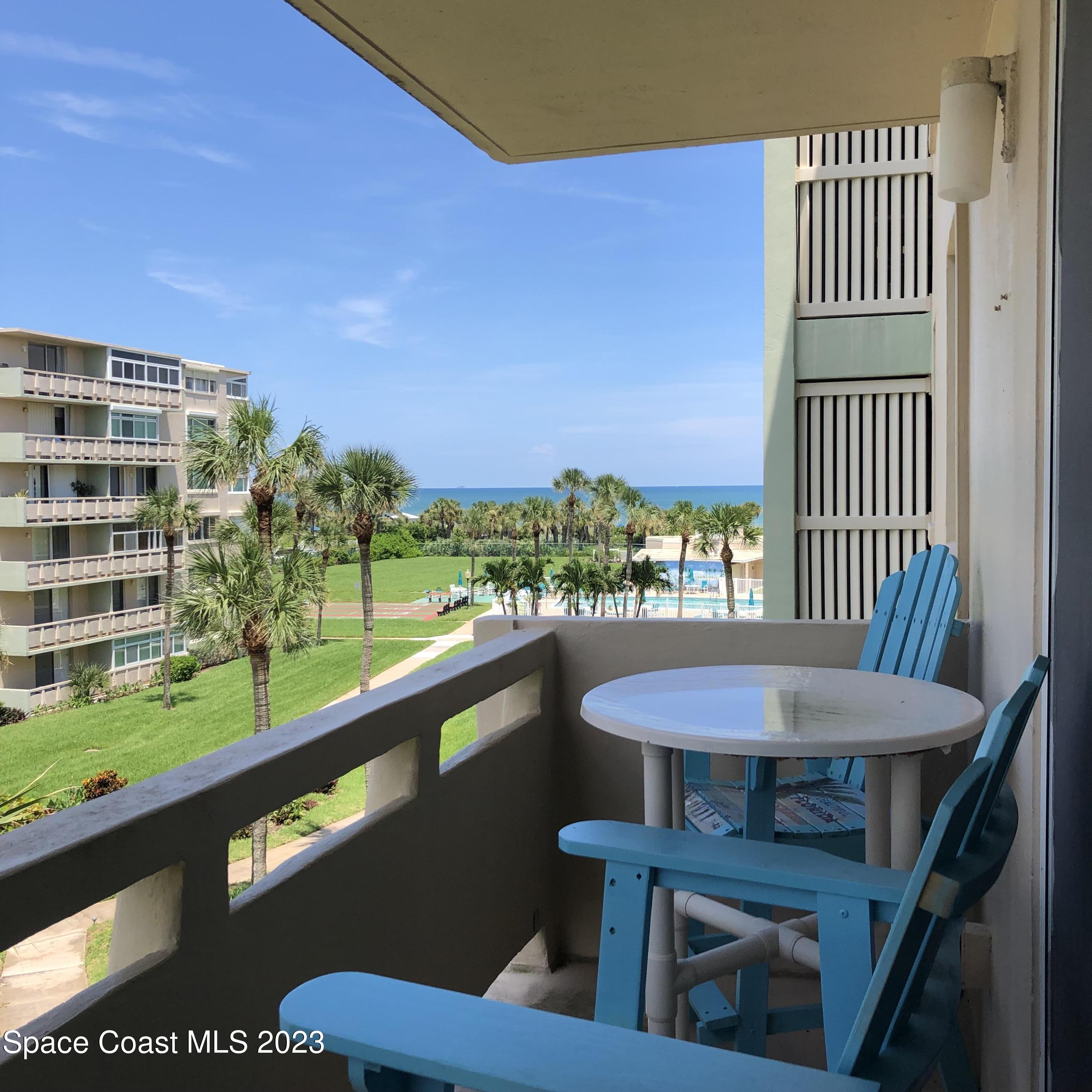 2020 North Atlantic Avenue, Unit 408S Cocoa Beach, FL 32931 - Photo 17 of 22 a view of a chairs and table in patio