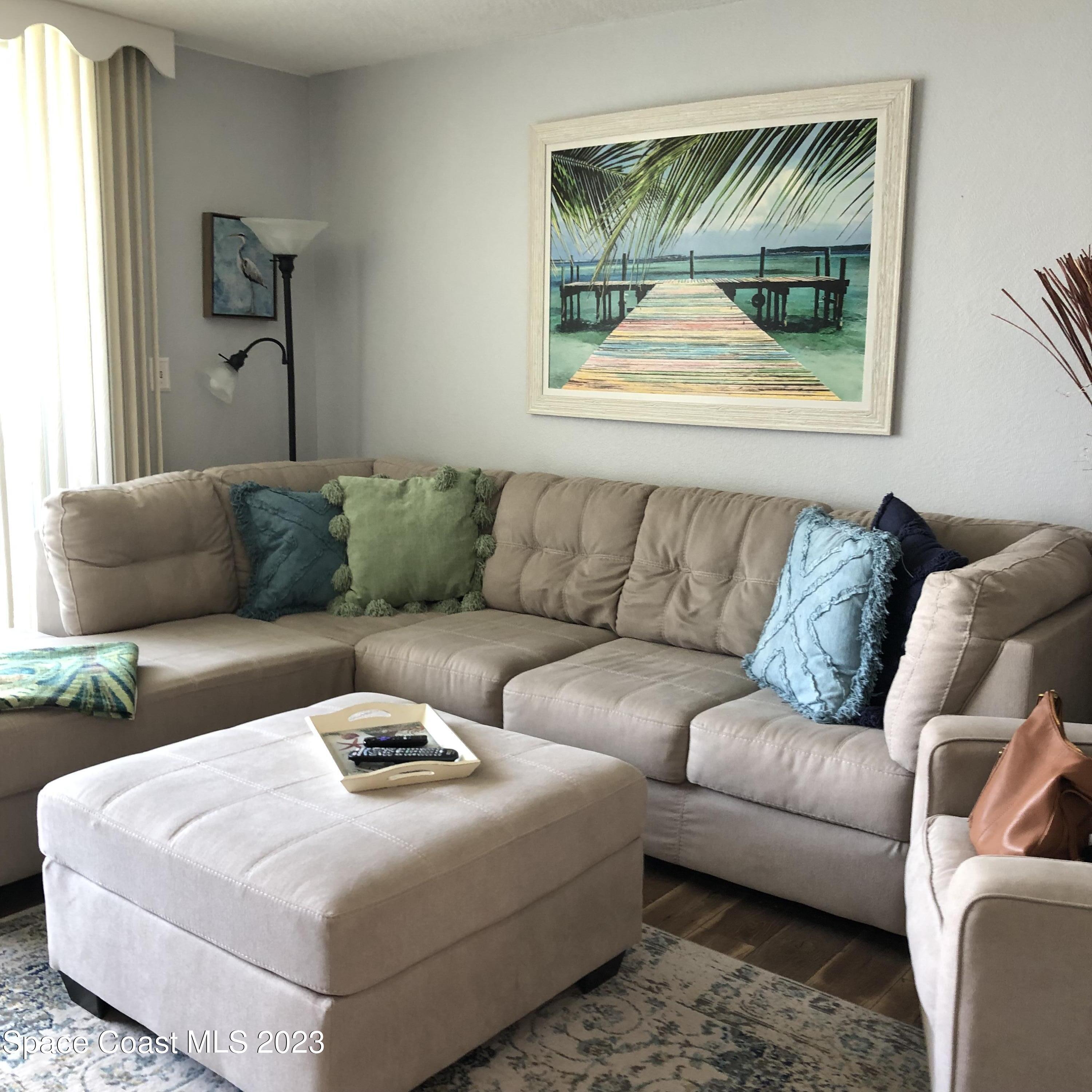2020 North Atlantic Avenue, Unit 408S Cocoa Beach, FL 32931 - Photo 4 of 22 a living room with furniture and a window