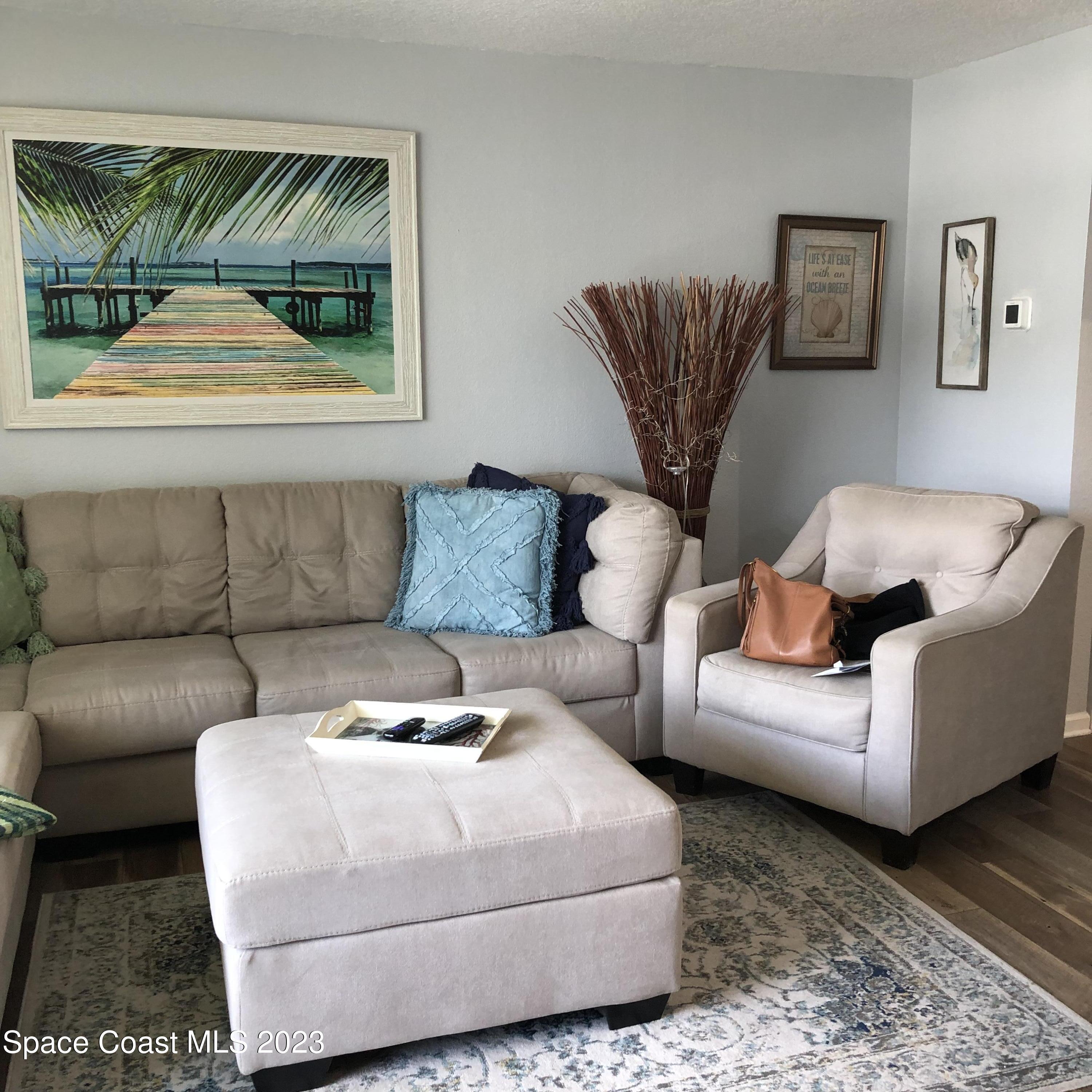 2020 North Atlantic Avenue, Unit 408S Cocoa Beach, FL 32931 - Photo 5 of 22 a living room with furniture and a large window