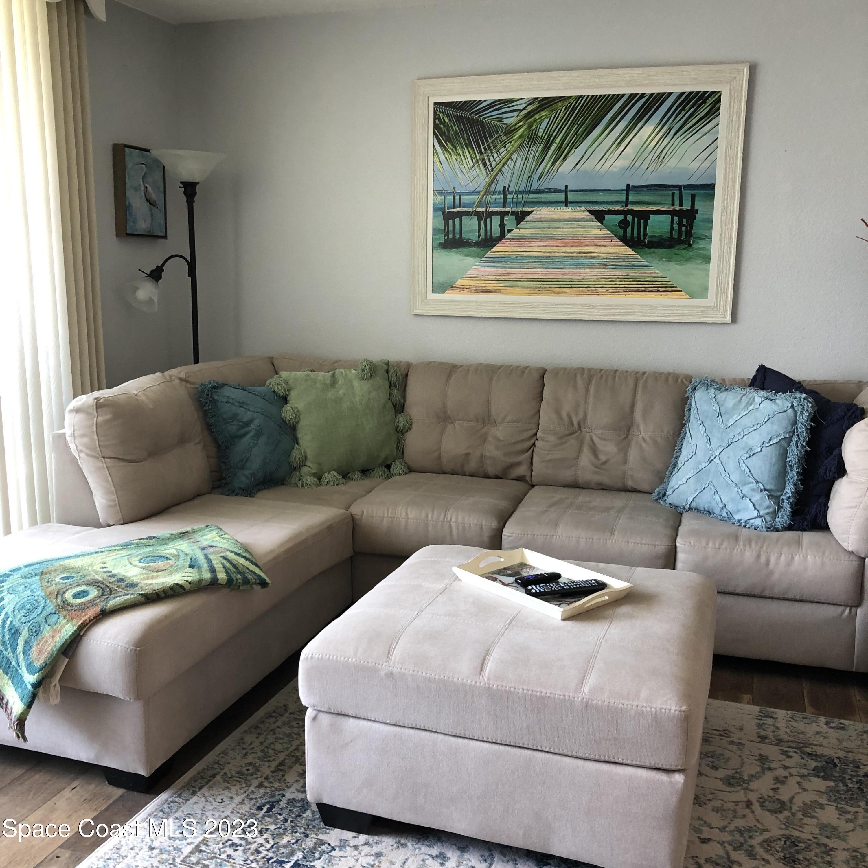 2020 North Atlantic Avenue, Unit 408S Cocoa Beach, FL 32931 - Photo 6 of 22 a living room with furniture and a window