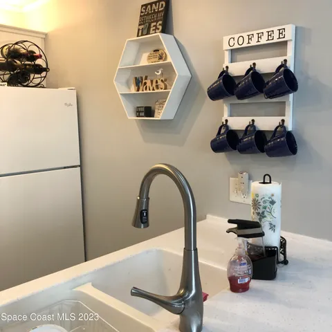 a white refrigerator freezer sitting inside of a kitchen