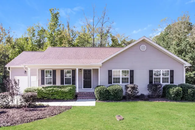 a view of a house with garden and yard