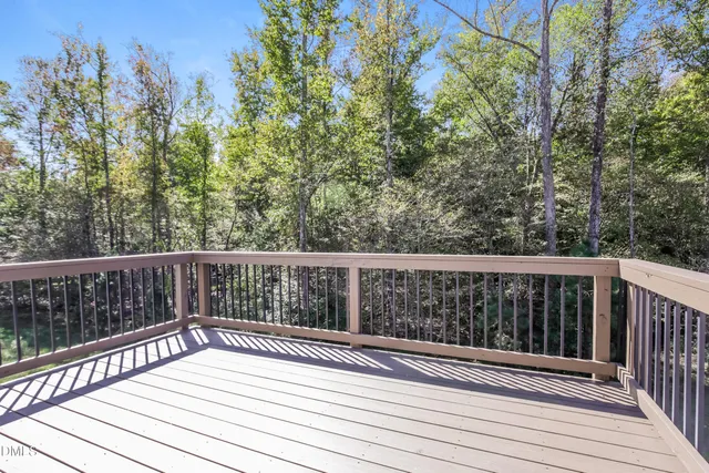 a view of balcony with wooden floor and fence