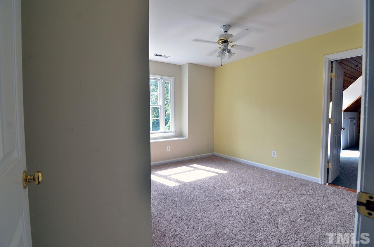 6000 Bunchberry Court Raleigh, NC 27616 - Photo 11 of 25 an empty room with a ceiling fan and a window