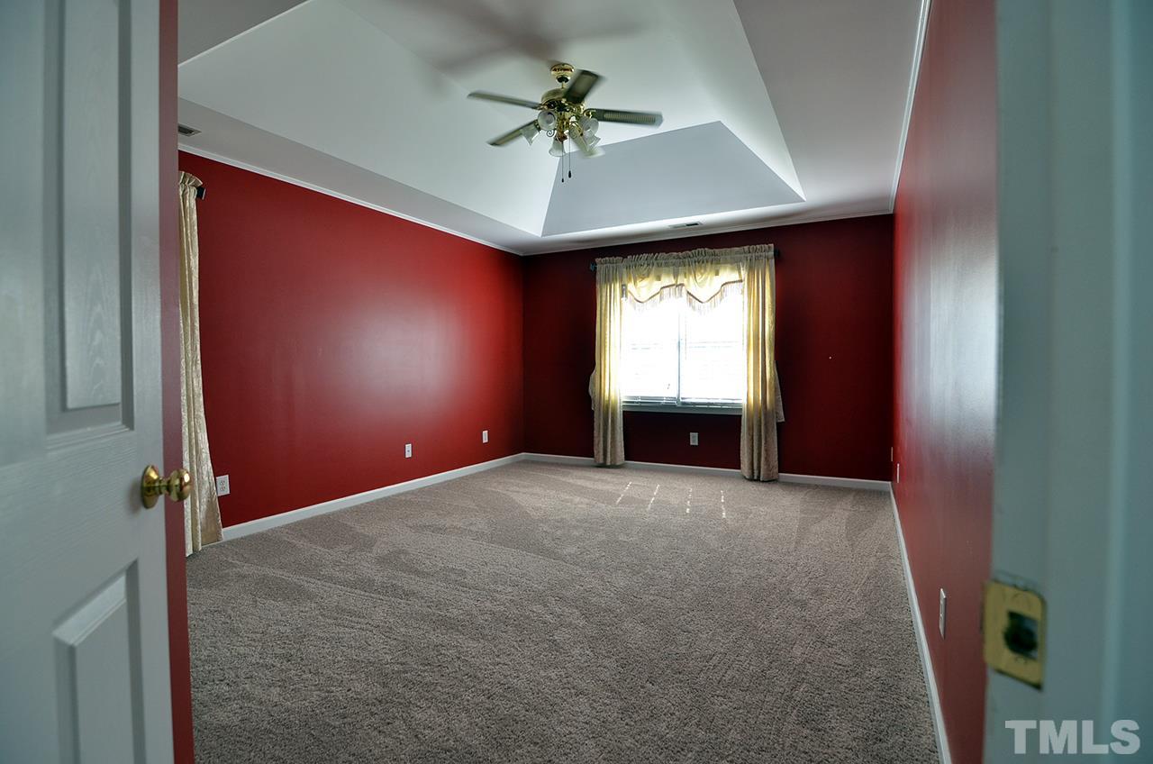 6000 Bunchberry Court Raleigh, NC 27616 - Photo 14 of 25 an empty room with windows and ceiling fan