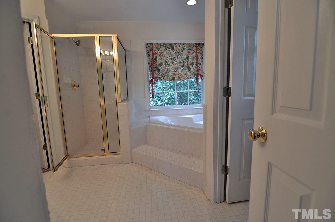 6000 Bunchberry Court Raleigh, NC 27616 - Photo 17 of 25 a bathroom with a tub and shower