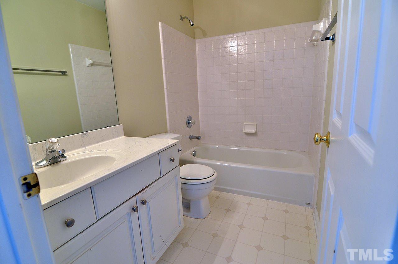 6000 Bunchberry Court Raleigh, NC 27616 - Photo 20 of 25 a bathroom with a sink a toilet and shower