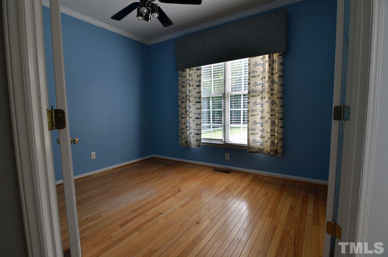 6000 Bunchberry Court Raleigh, NC 27616 - Photo 4 of 25 a view of an empty room with a window and wooden floor