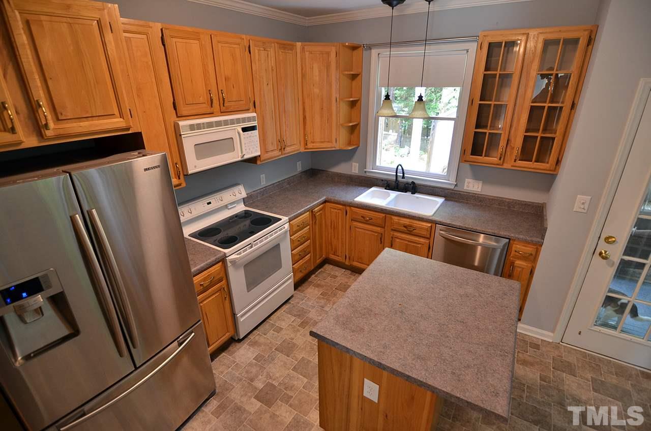 6000 Bunchberry Court Raleigh, NC 27616 - Photo 7 of 25 a kitchen with sink refrigerator and window