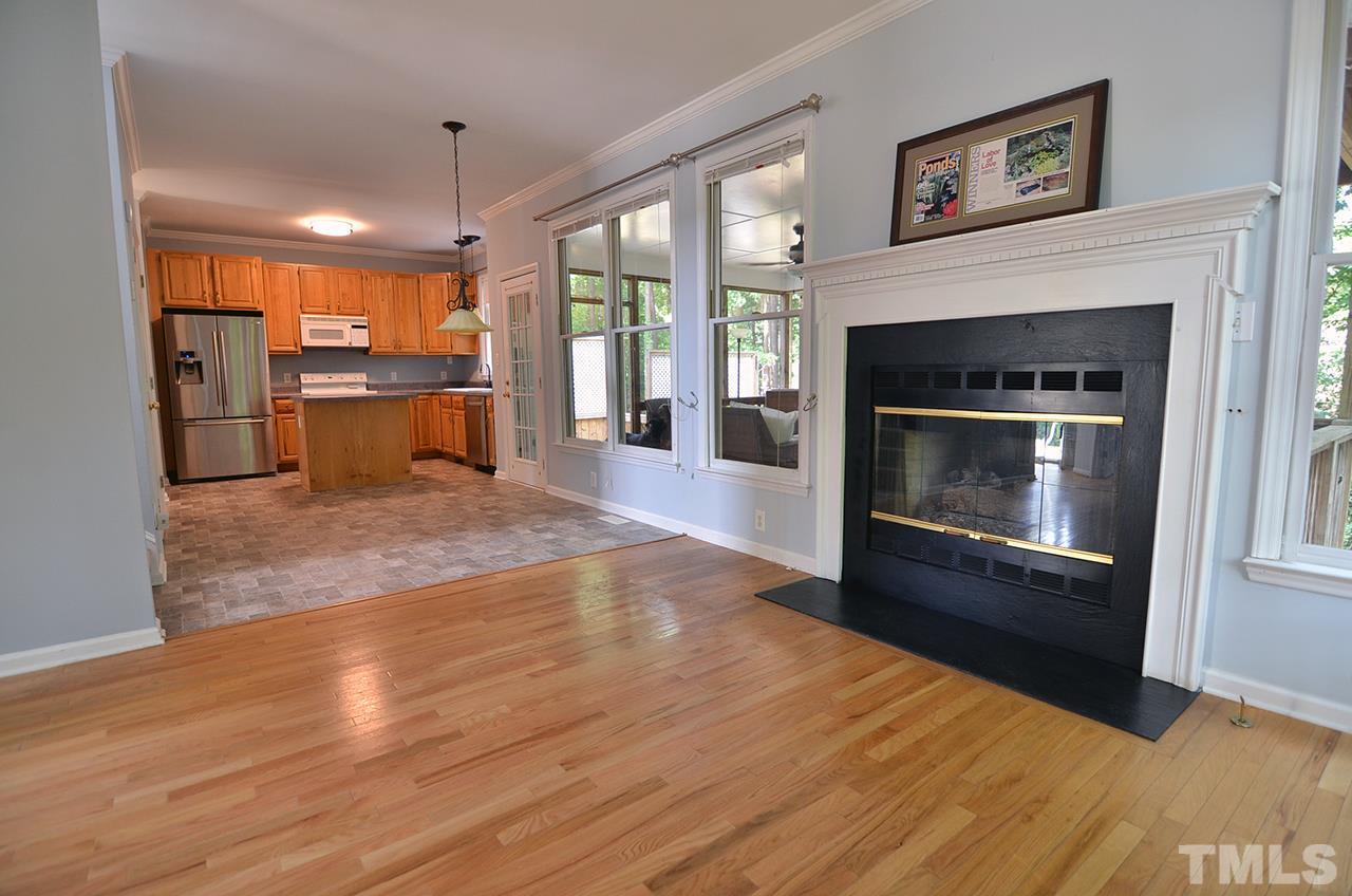 6000 Bunchberry Court Raleigh, NC 27616 - Photo 9 of 25 a view of open kitchen with granite countertop a stove top oven a sink and a fireplace