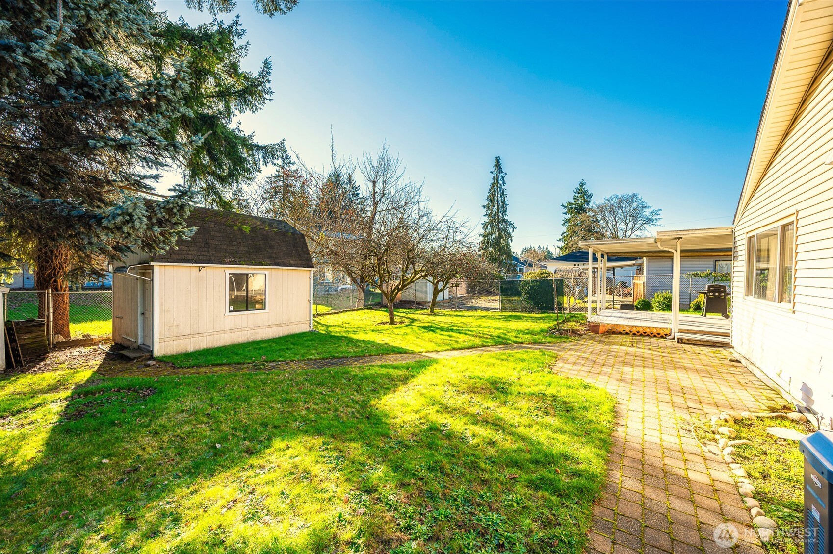 9116 121st Street Southwest Lakewood, WA 98498 - Photo 23 of 24 a view of a house with swimming pool and a yard