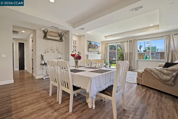 a living room with furniture and kitchen view