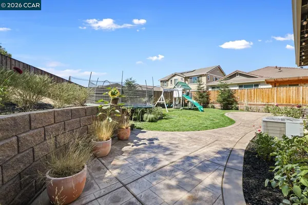 a view of a backyard with wooden fence