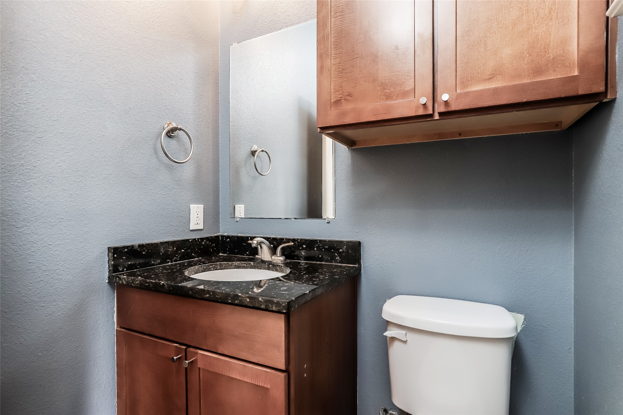 1701 Sanchez Street, Unit A Austin, TX 78702 - Photo 15 of 19 A well-appointed bathroom vanity features a dark granite countertop and a contemporary sink.
