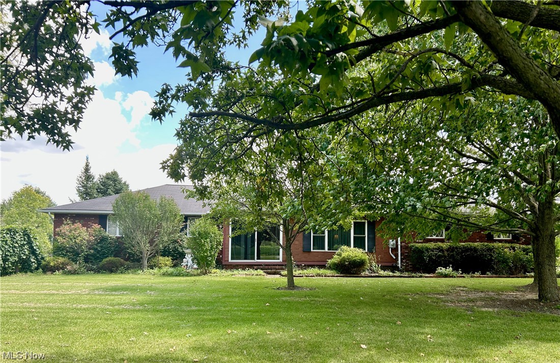 16783 Whitehead Road Lagrange, OH 44050 - Photo 1 of 1 Front view of the home showing beautiful trees and lawn.