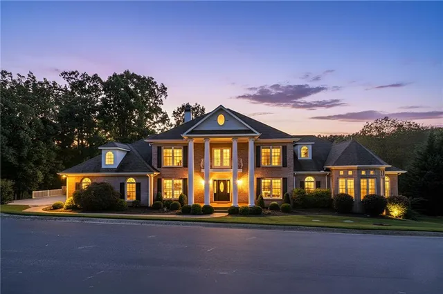 a front view of a residential apartment building with a yard