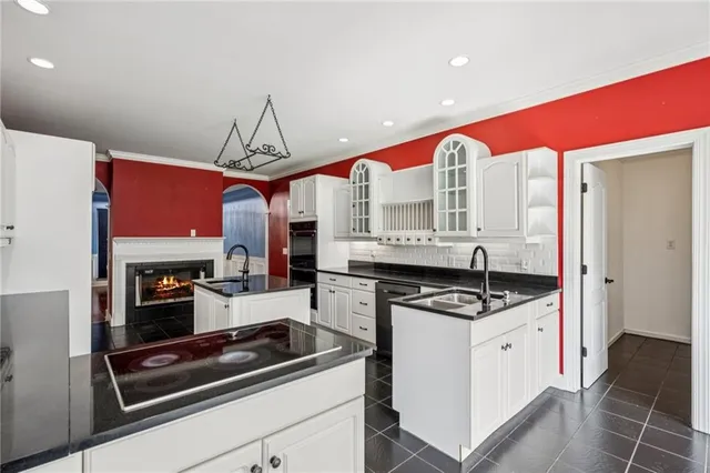 an empty room with wooden floor a fireplace and a window