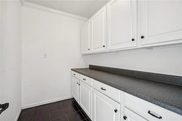 an empty room with a empty space and windows