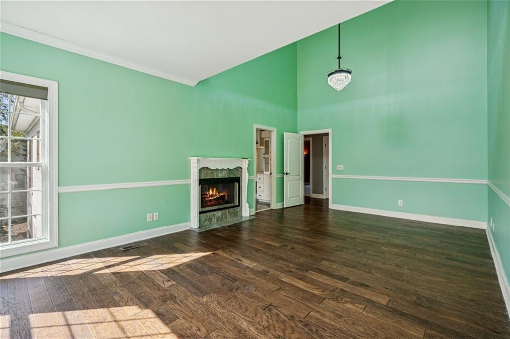 181 Granny Smith Circle Clarkesville, GA 30523 - Photo 29 of 79 an empty room with wooden floor a fireplace and a window