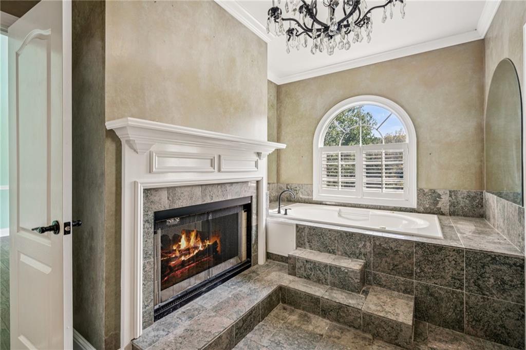 181 Granny Smith Circle Clarkesville, GA 30523 - Photo 32 of 79 a living room with a fireplace a large window and a fireplace