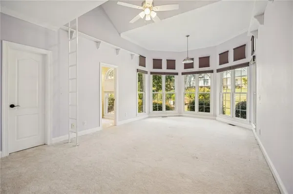 a view of an empty room and a bathroom