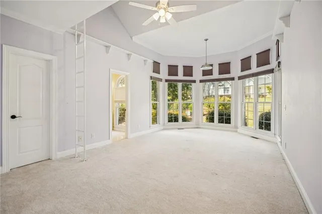 a view of an empty room and a bathroom