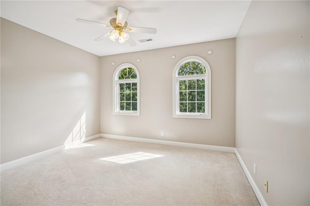 181 Granny Smith Circle Clarkesville, GA 30523 - Photo 52 of 79 an empty room with windows and chandelier fan